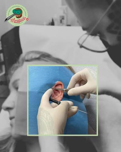 Professional piercer using a Mosquito needle in studio